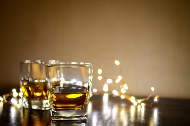 what's special about Japanese whisky - two whisky glasses on a table with a string of glowing lights around